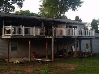 Fire Damaged Home - Back View BEFORE, insurance repair contractor